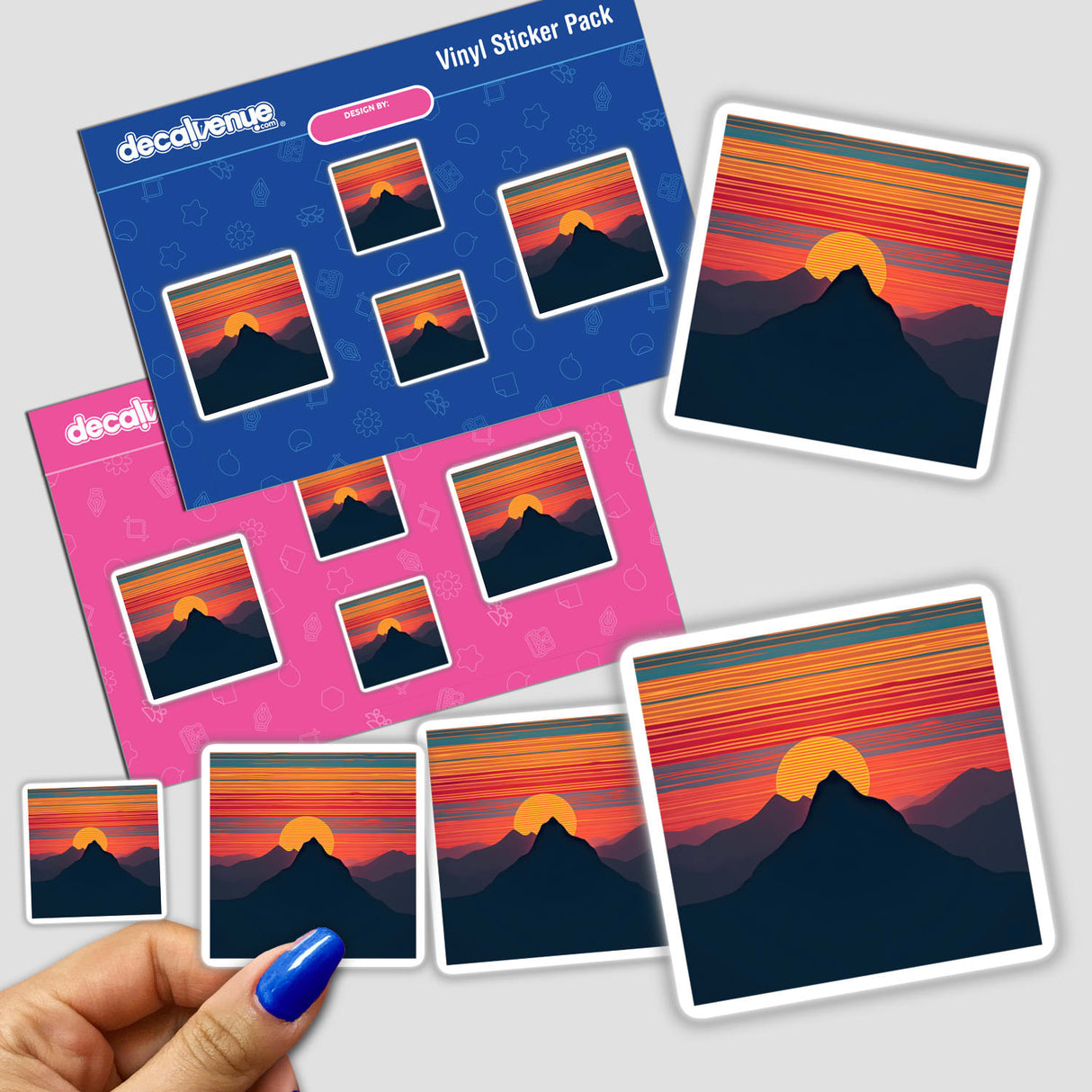 Sticker pack titled Mountain Range Silhouette in Dynamic Color Stripes showing vibrant mountain and sunset designs, held by a hand with blue nail polish.