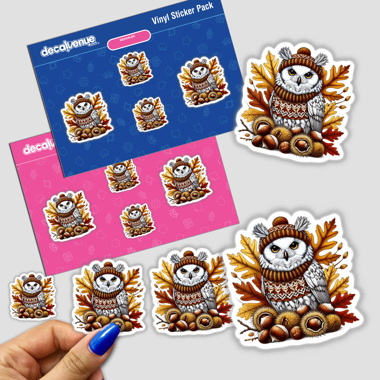 Sticker featuring Autumn Owl in Cozy Sweater surrounded by leaves and acorns. Close-up of hand holding the sticker, showcasing the owl's detailed hat and scarf.