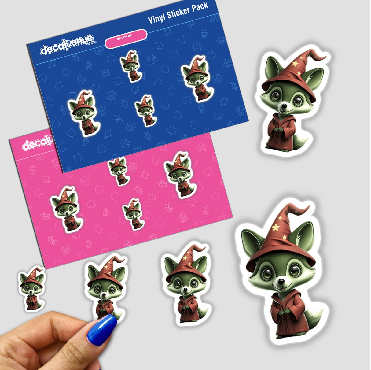 a hand holding a sticker next to a pack of stickers