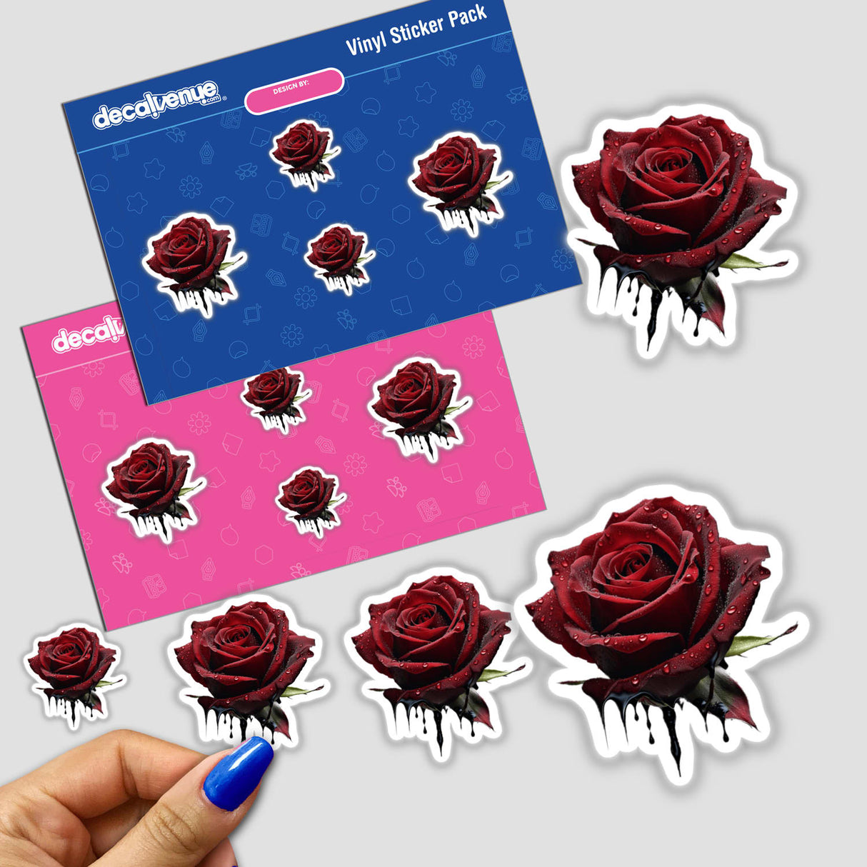 a hand holding a sticker of a red rose