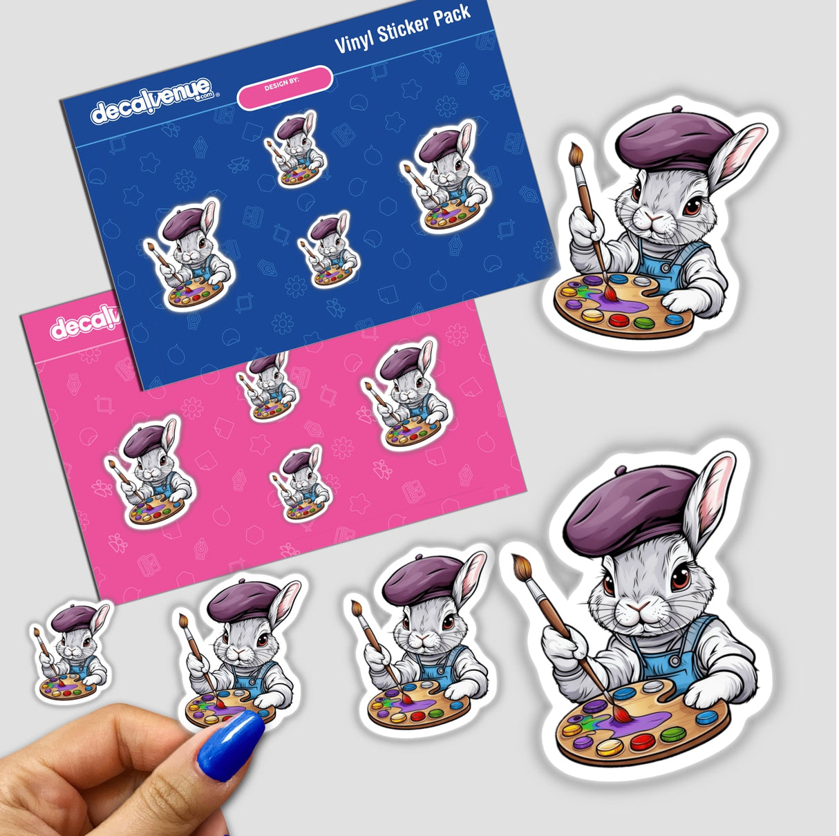 a hand holding a sticker next to a set of stickers