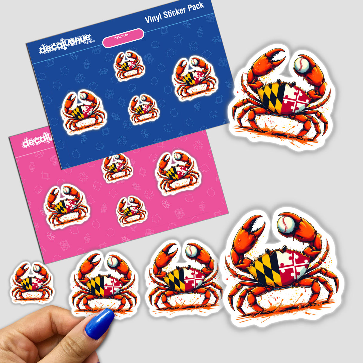 Maryland Steamed Baseball Crab sticker pack features a blue-crab with Maryland flag carapace and baseball, shown on branded cards and held as smaller decals, celebrating unique vinyl art.