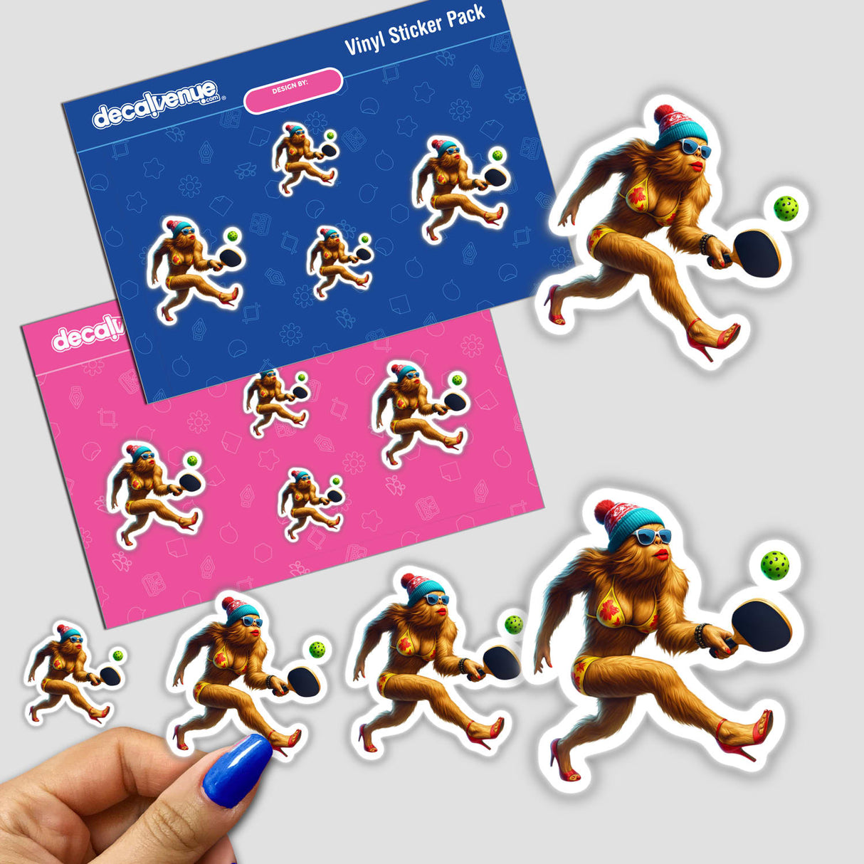 Female Bigfoot in Bikini and Heels Playing Pickleball vinyl sticker pack featuring whimsical die-cut designs; includes multiple sizes with a hand holding the smallest sticker for scale. Available as stickers or digital artwork.