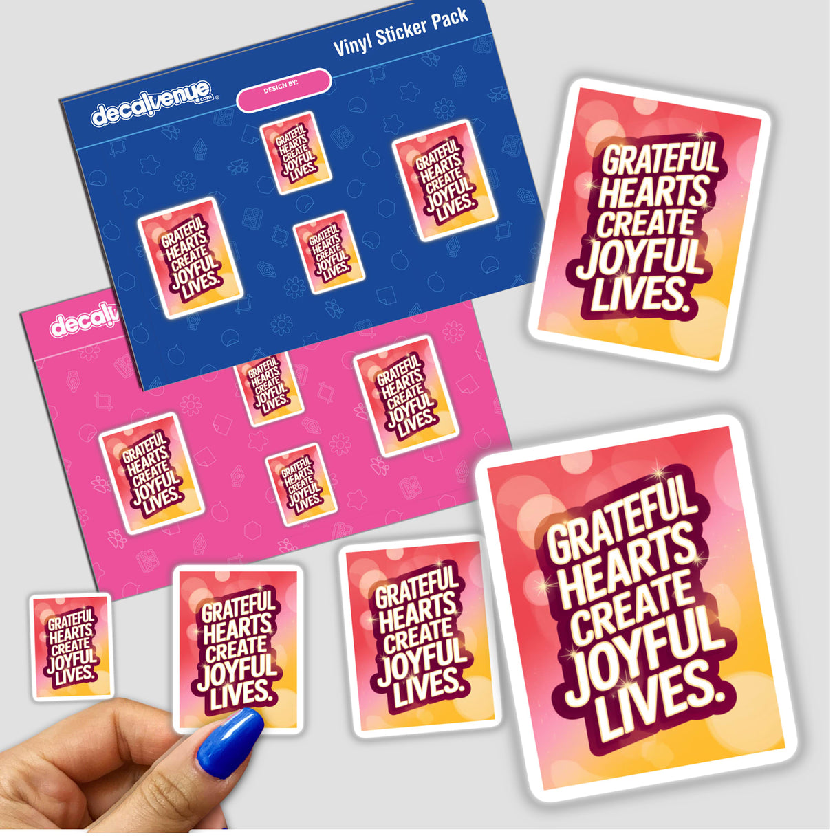 Hand holding a sticker pack titled Grateful hearts create joyful lives, showcasing diverse designs, available as both stickers and digital artwork from Decal Venue.