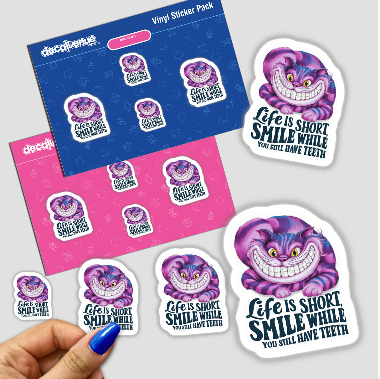 Colorful digital artwork stickers featuring the Cheshire Cat from Alice in Wonderland, with the text "Life is short. Smile while you still have teeth", displayed on a Vinyl Sticker Pack from Decal Venue.