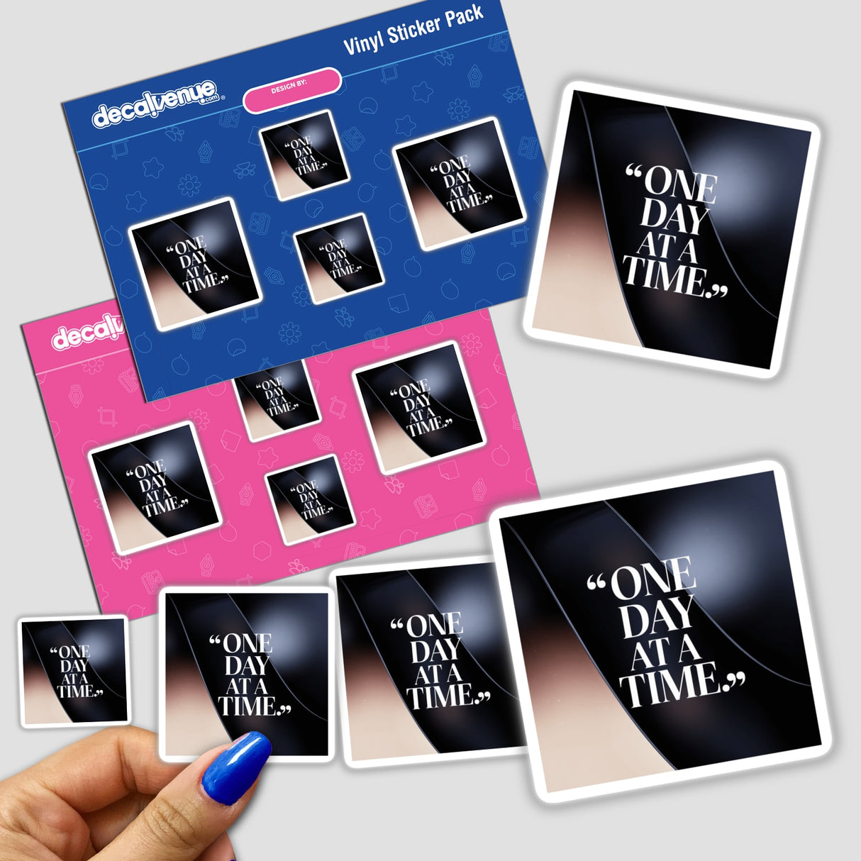 Hand holding the One day at a time sticker pack, showcasing unique vinyl stickers designed for motivational appeal, available as physical stickers or digital artwork from Decal Venue.