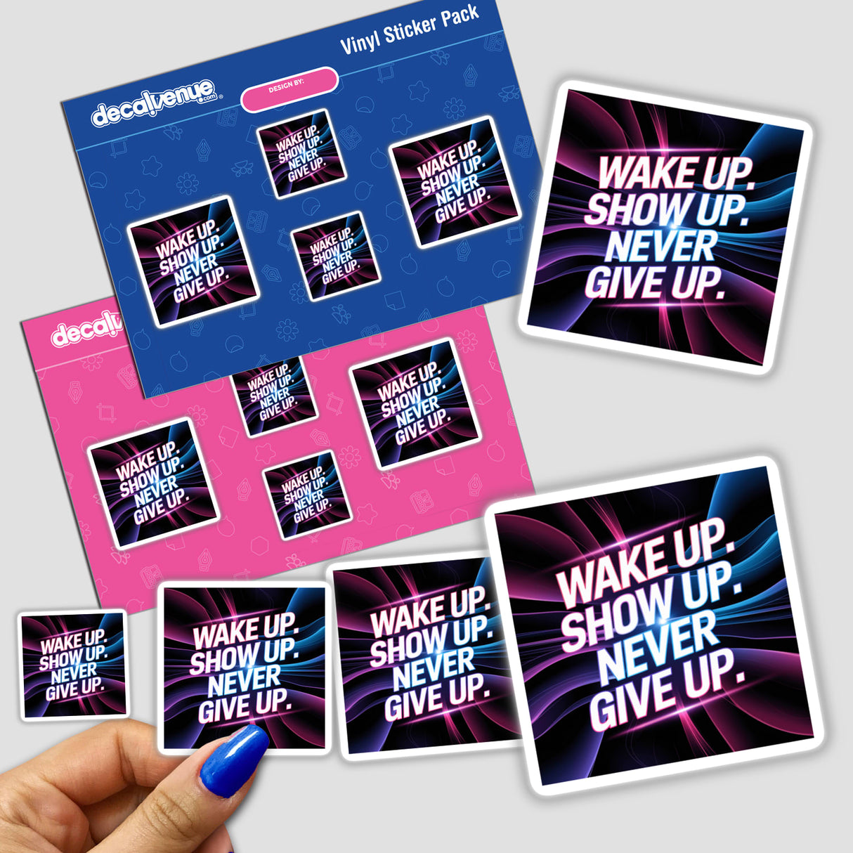 Hand holding a sticker pack titled Wake up. Show up. Never give up, featuring various designs, showcasing Decal Venue's unique vinyl sticker collection.