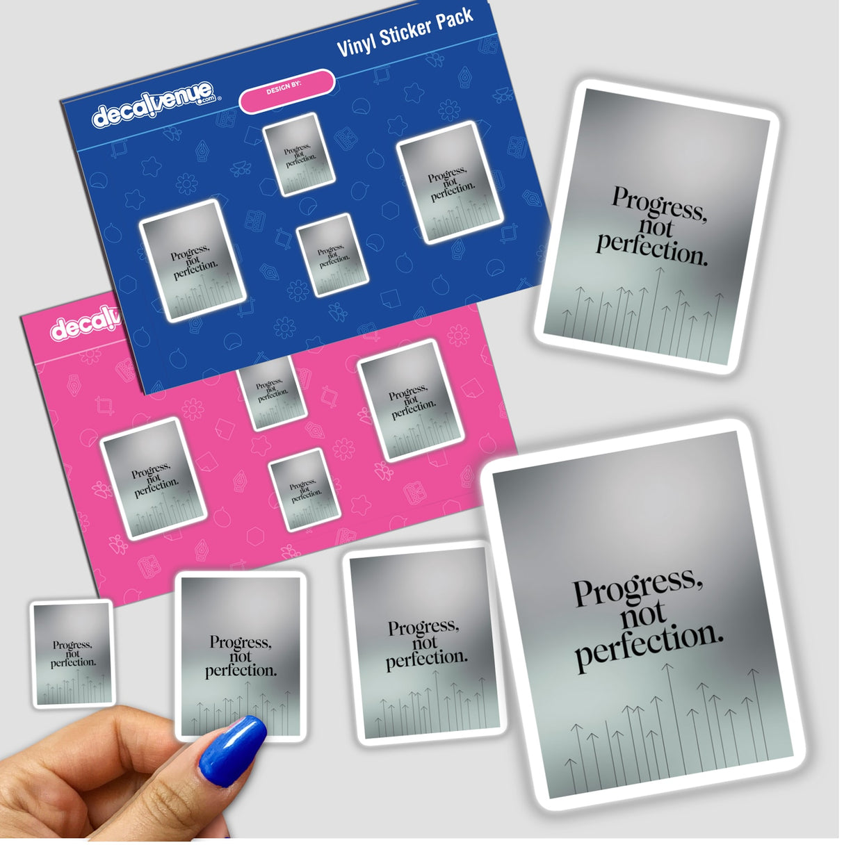 A hand holds a Progress, not perfection sticker pack, showcasing Decal Venue's unique vinyl stickers, ideal for stationery enthusiasts or digital artwork fans seeking motivational designs.