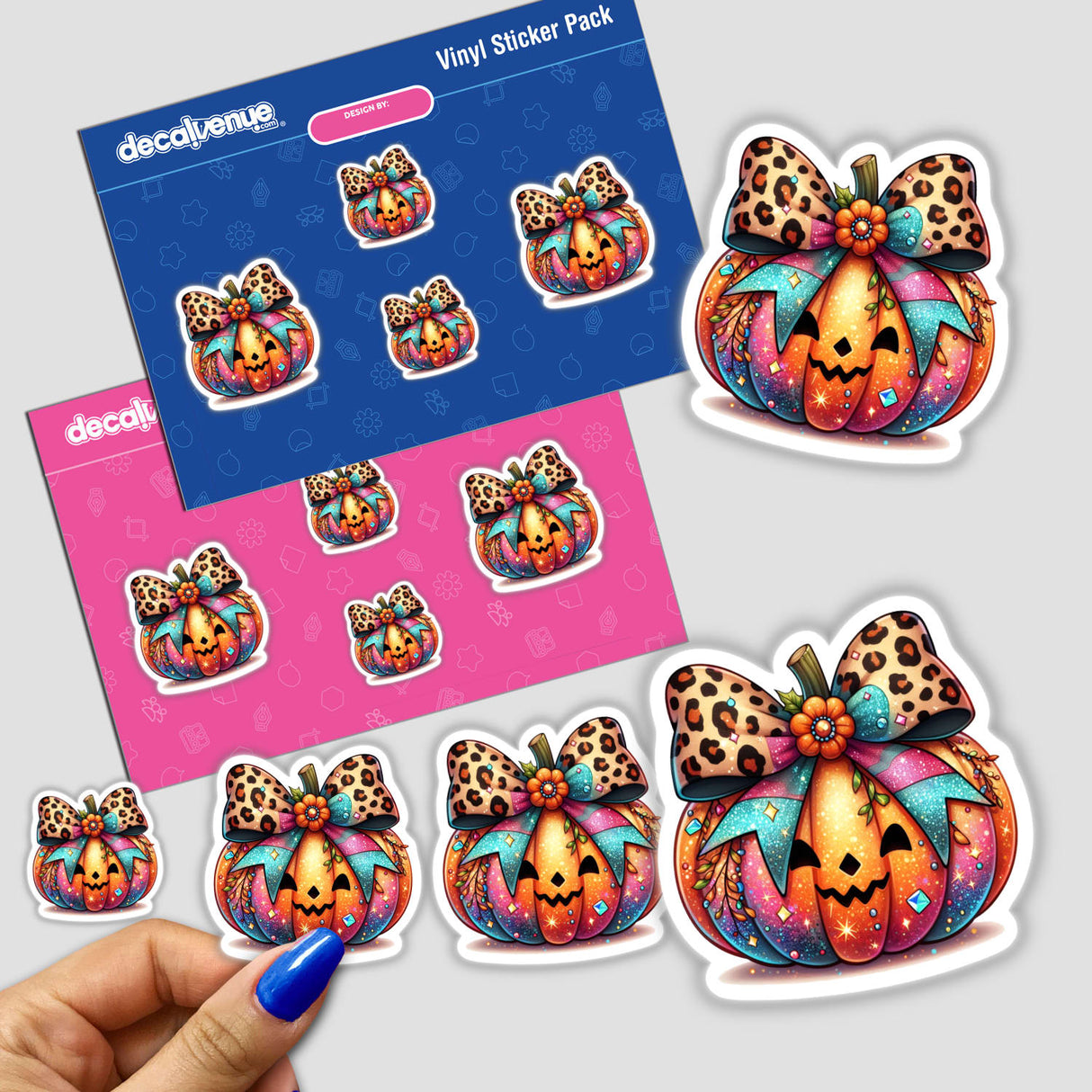 Vibrant pumpkin-shaped stickers with leopard print bows, displayed on a pink and blue background from the Decal Venue store. The stickers feature intricate, colorful designs that would be perfect for decorating or expressing one's style.