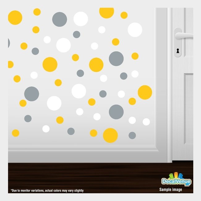 Colorful polka dot circles wall decals in yellow, metallic silver, and white, displayed on a white wall with a door frame. The decals are a creative and stylish way to add visual interest and personality to a room.