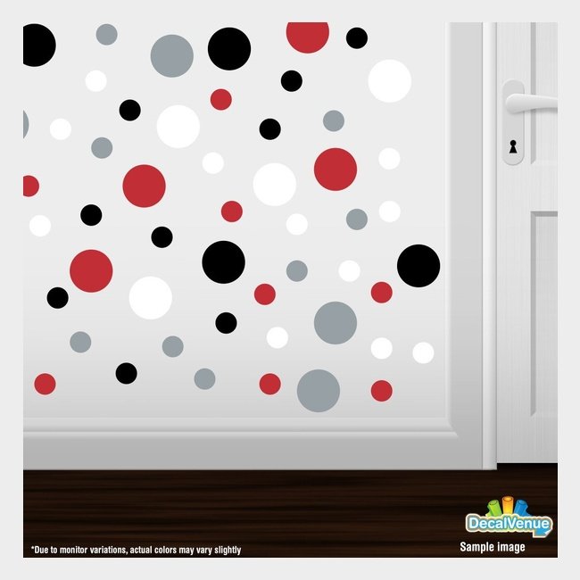 Colorful polka dot circles wall decals displayed on a white wall surface near a door handle.