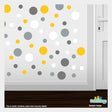 Yellow, grey, silver, and white polka dot circles wall decals on a bright background