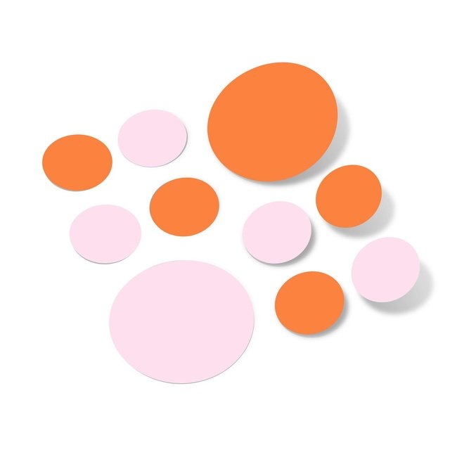Baby pink and orange polka dot circle wall decals on a white background.