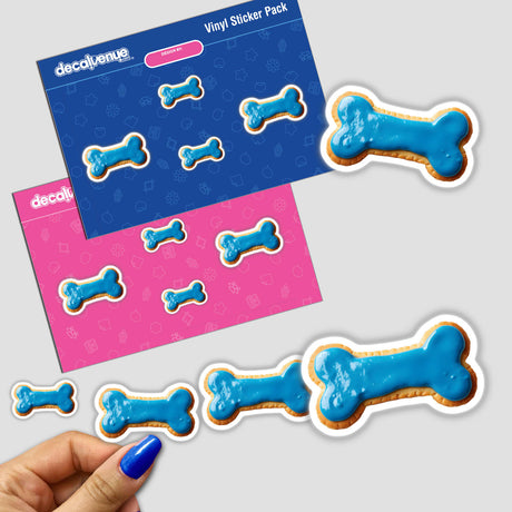 Dog Bone Shaped Cookie with Blue Icing sticker pack featuring various blue frosted bone designs and a close-up of a fingernail painting a cookie.