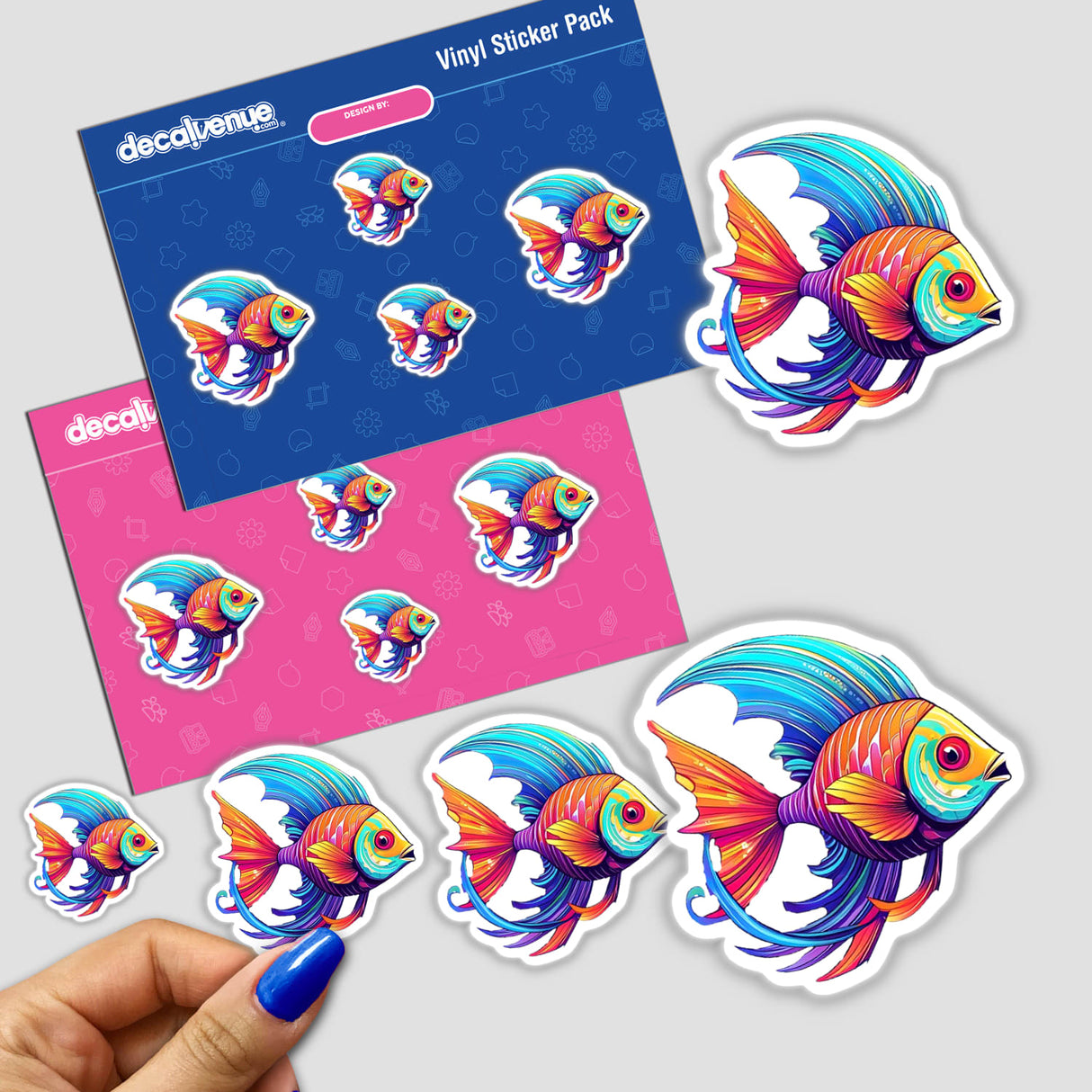 Colorful angel fish vinyl stickers displayed in a Decal Venue product pack. The stickers feature vibrant, detailed illustrations of tropical fish with intricate patterns and fins. The stickers are presented against a bright pink and blue background, showcasing the eye-catching design.