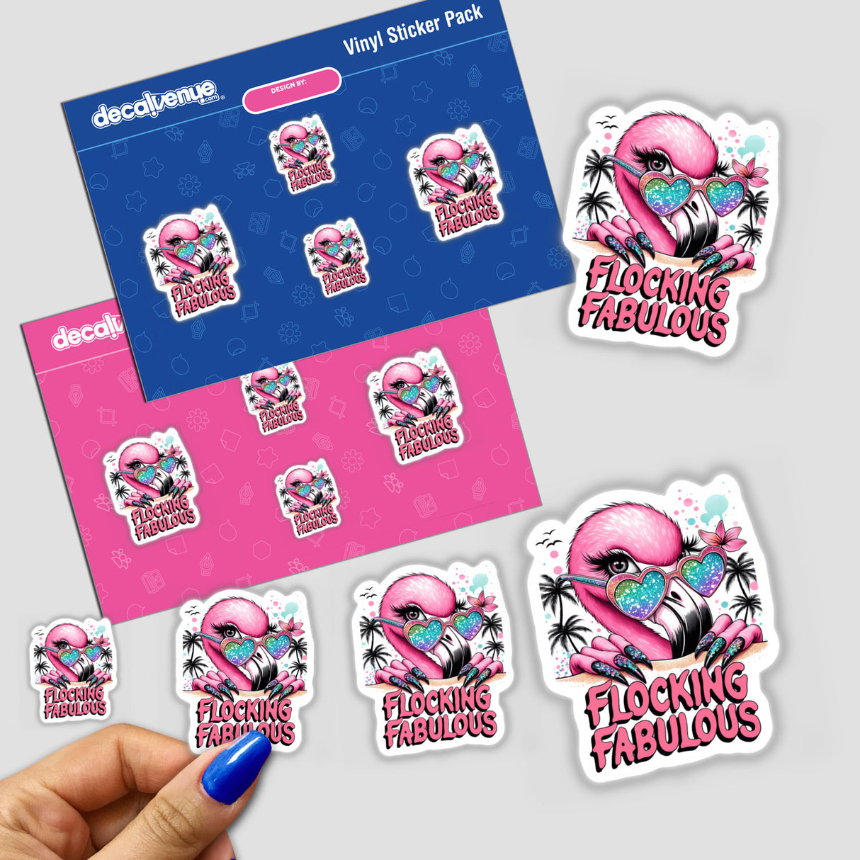 Colorful flamingo-themed prismatic stickers with text "Flocking Fabulous" on a pink and blue vinyl sticker pack displayed and held in a hand.