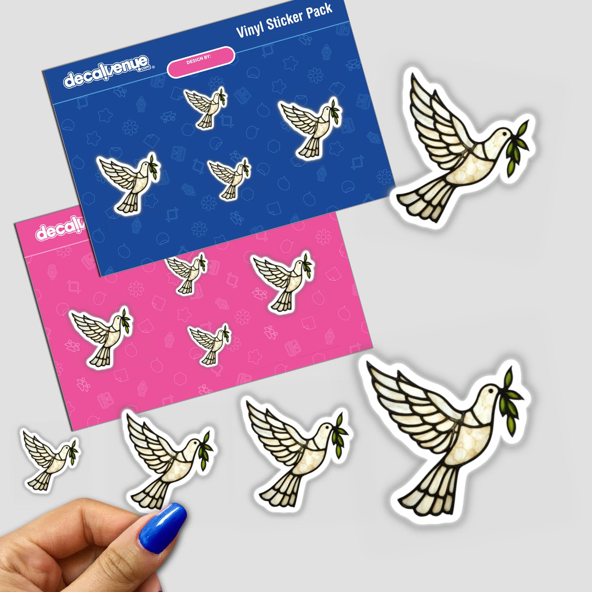 Stained Glass Dove Descending with Olive Branch Clipart; hand holds dove-themed stickers, showcasing product's artistic and commercial appeal. Available as stickers or digital artwork from Decal Venue.
