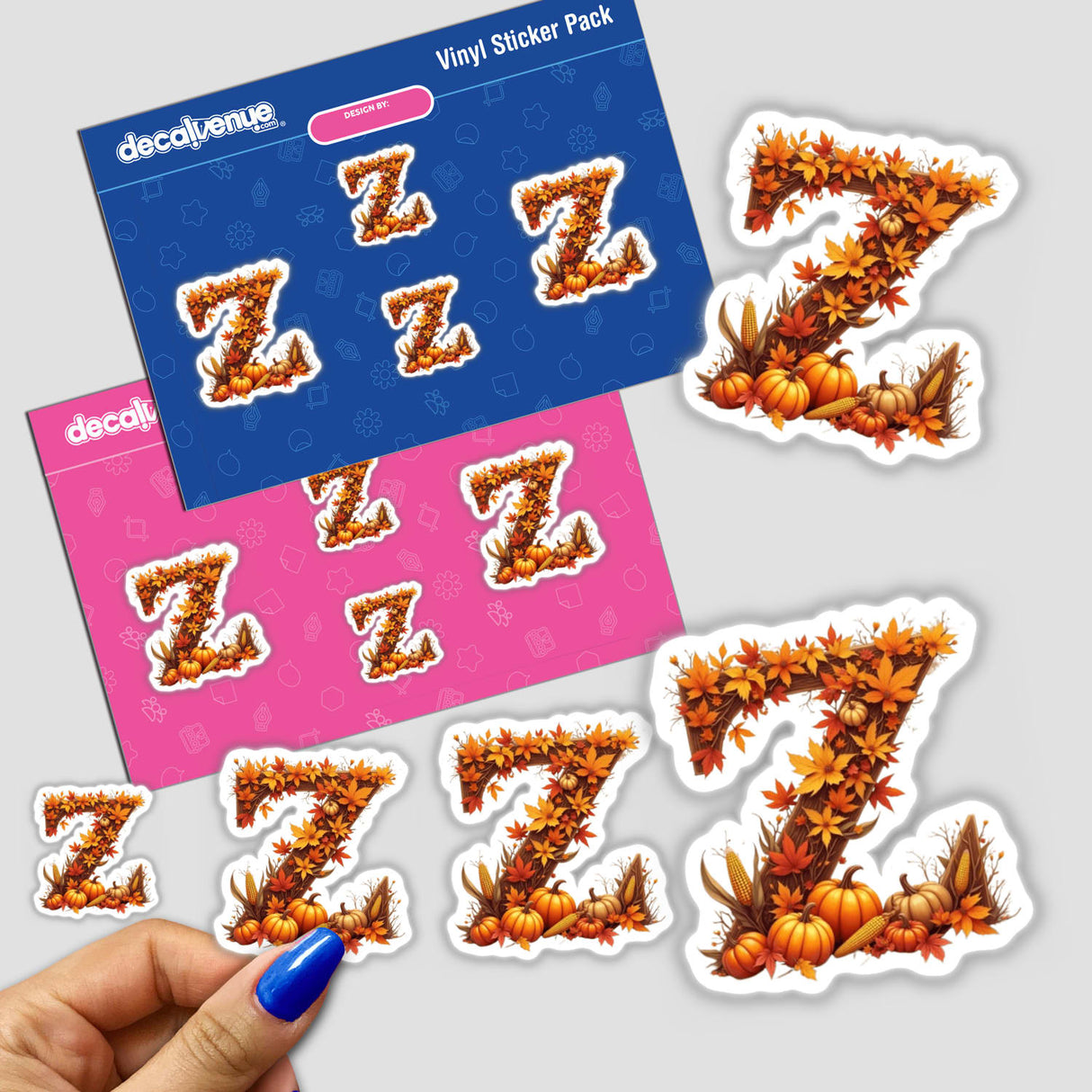 Hand holding a Fall Aesthetic Letter Z Clipart sticker featuring pumpkins and fall leaves, available as stickers or digital artwork with commercial rights.