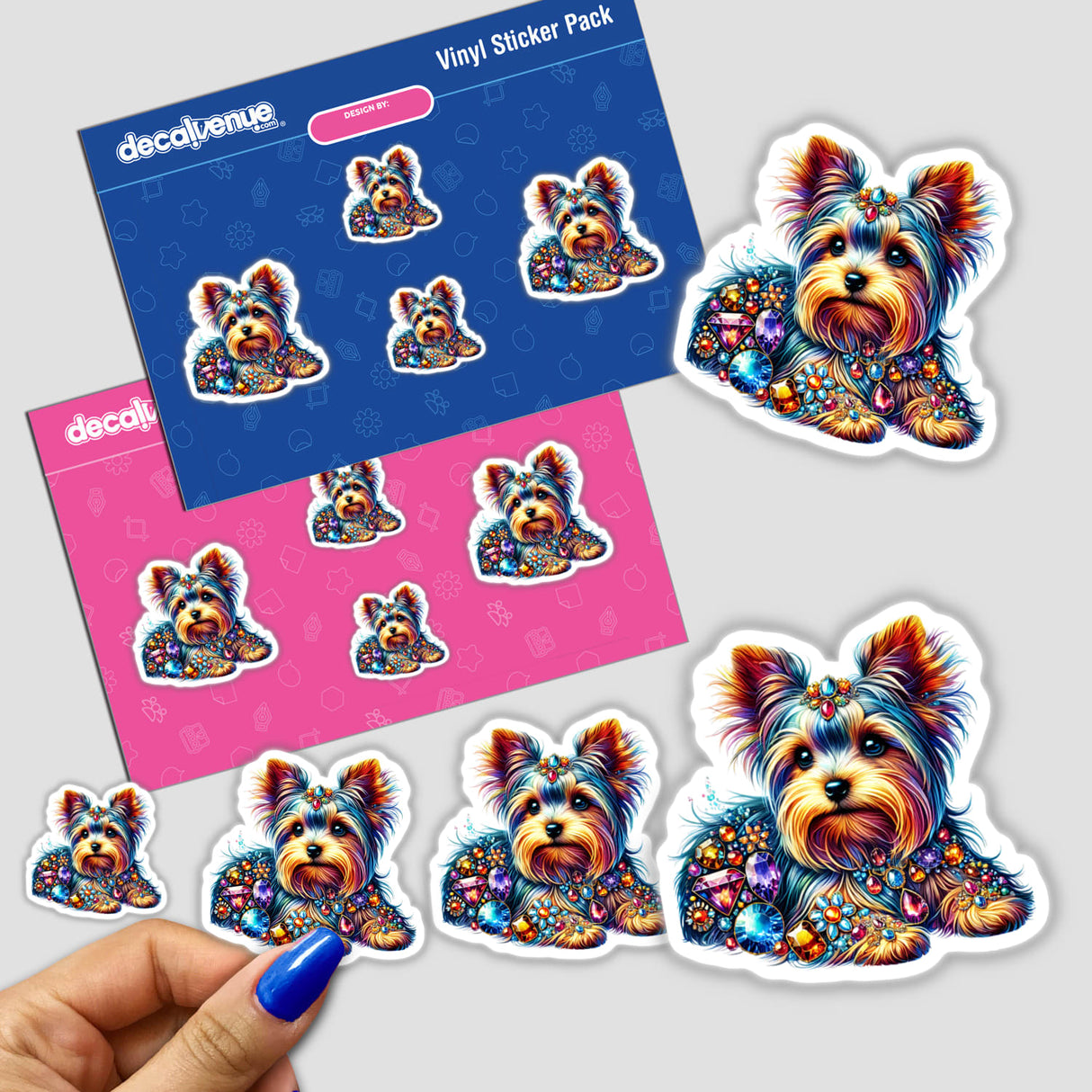 Hand holding a Yorkie Jewels and Gemstones sticker pack, featuring colorful cartoon dogs adorned with jewels. Available as stickers or digital artwork.