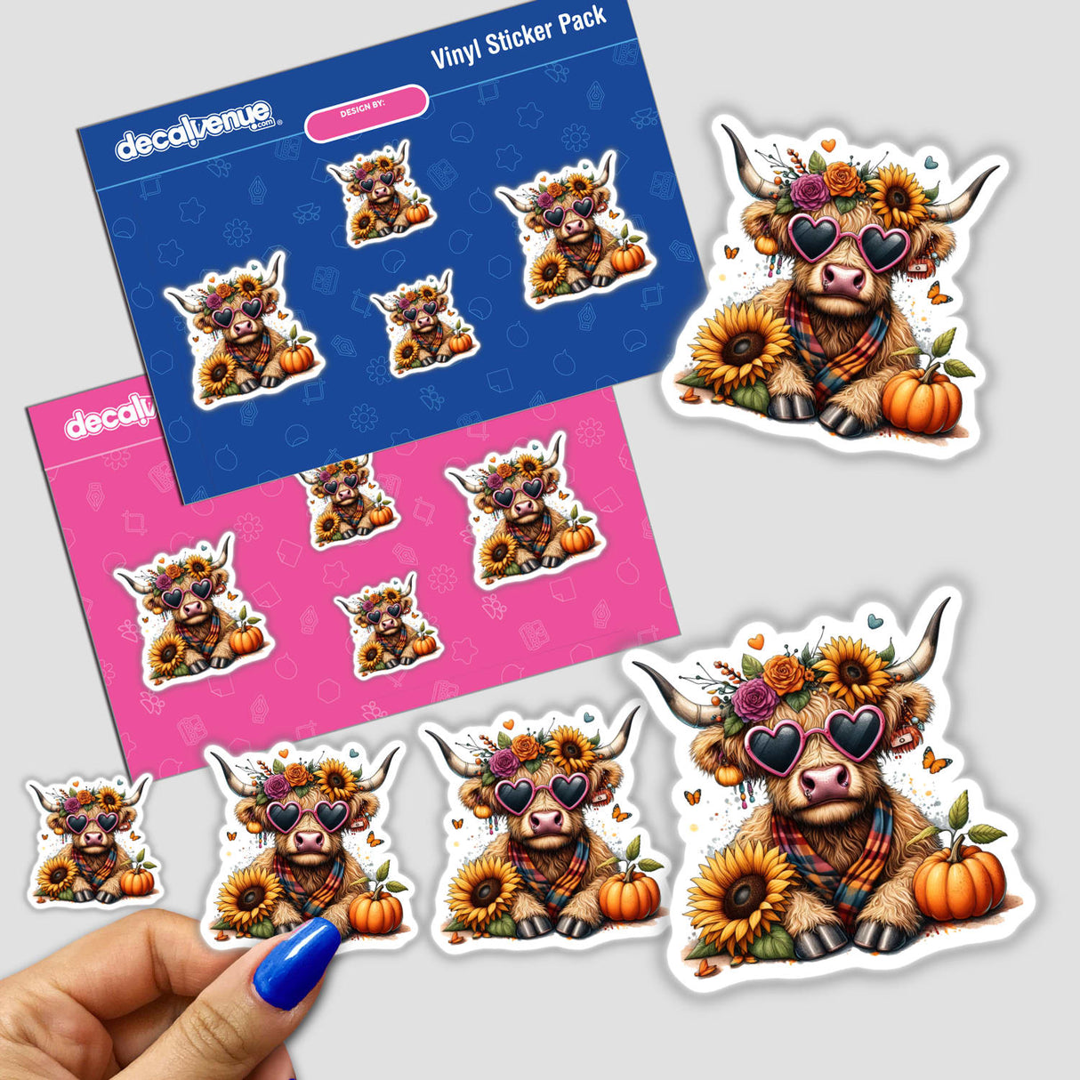 Stickers of a Fall Highland Cow wearing sunglasses, adorned with sunflowers and pumpkins, close-up of a hand holding the sticker pack.