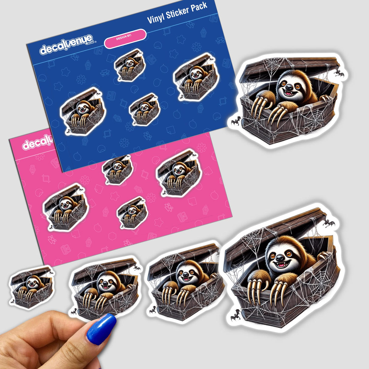 Colorful Halloween-themed vinyl stickers featuring a sloth peeking out of a coffin against a spiderweb backdrop, showcased on a Decal Venue product packaging.