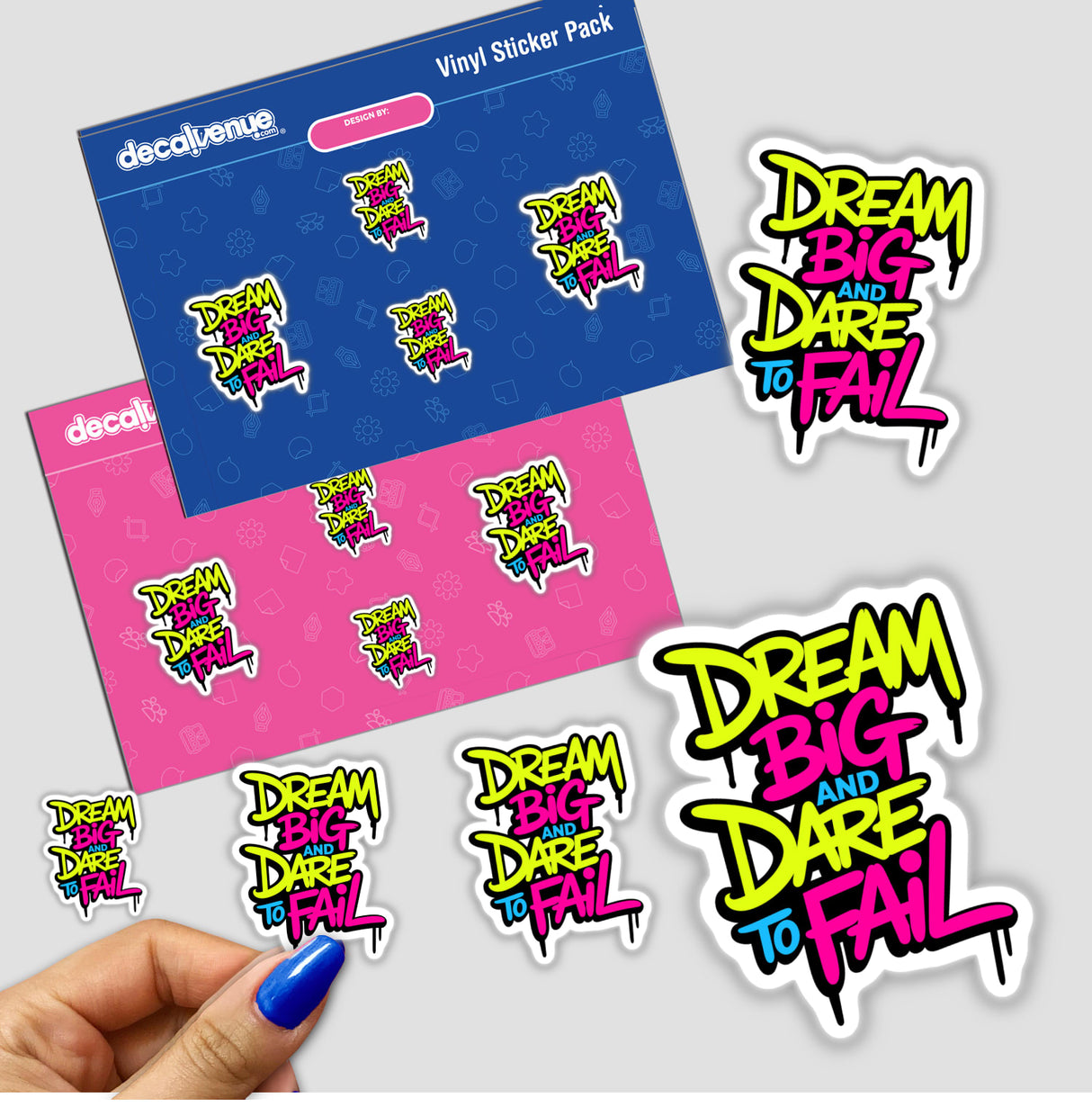 Hand holding a Dream Big And Dare To Fail motivational sticker, showcasing vibrant, artistic text design, available as a sticker or digital artwork from Decal Venue.