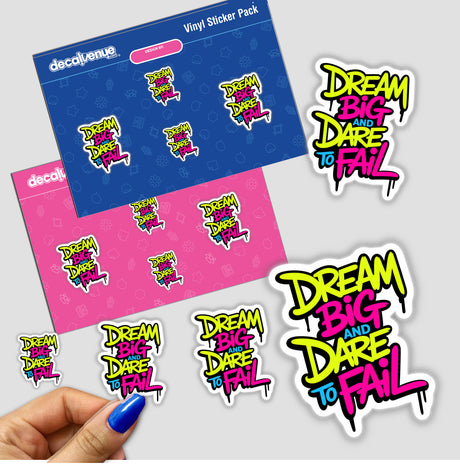 Hand holding a Dream Big And Dare To Fail motivational sticker, showcasing vibrant, artistic text design, available as a sticker or digital artwork from Decal Venue.