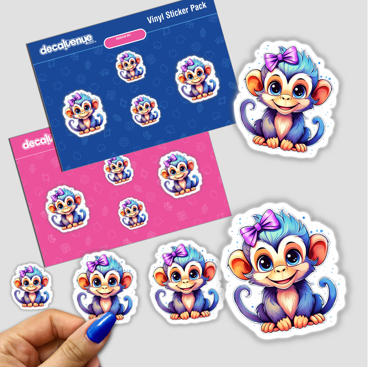 Baby monkey-themed stickers and envelopes featuring cartoon monkeys with bows, shown close-up with a person's hand for scale. Available as stickers or digital artwork.