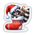Cute Santa Raccoon in Christmas Stocking sticker or digital art, featuring a cartoon raccoon in a Santa hat holding a candy cane within a festive stocking.