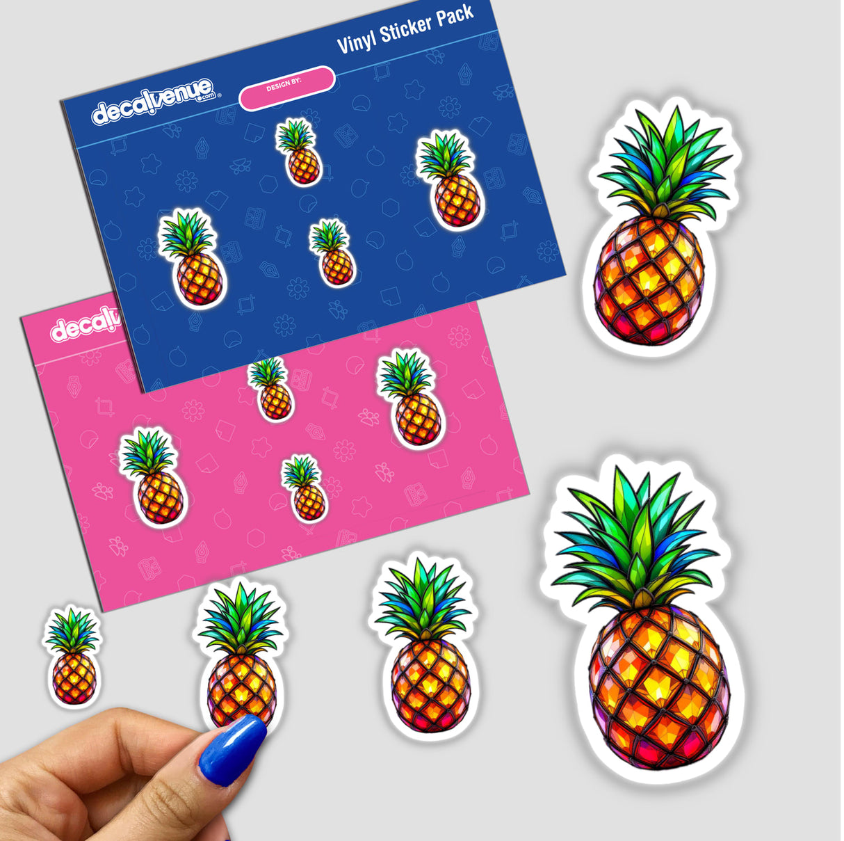 Pineapple Stained Glass Style sticker pack held in hand, showcasing intricate pineapple designs. Available as stickers or digital artwork, highlighting Decal Venue's unique artistic offerings.