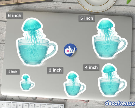 Whimsical Jellyfish Floating in a Teacup vinyl stickers, displayed in various sizes on a laptop lid. Includes a small dv logo and decalvenue branding, showcasing Decal Venue's unique sticker artistry.