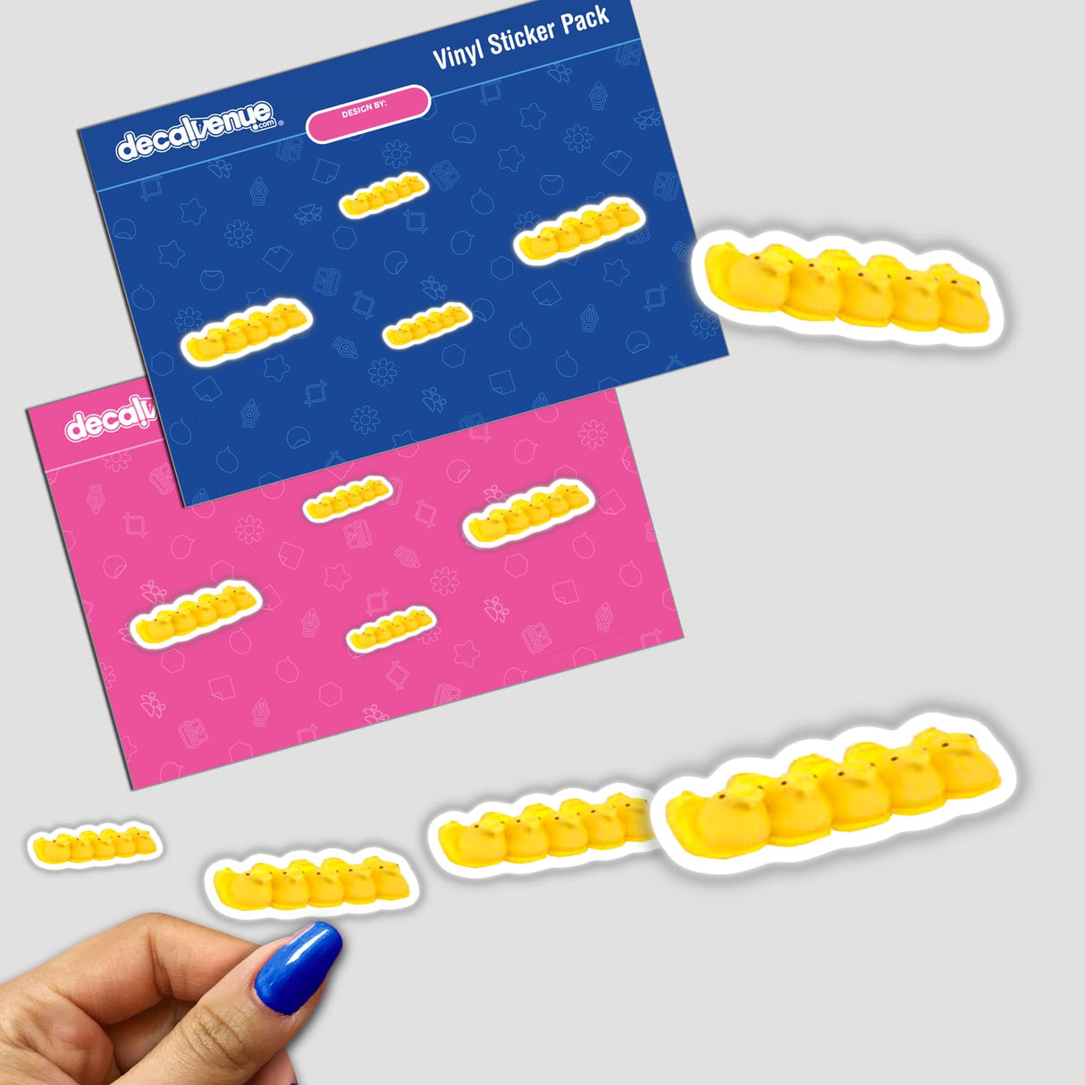 Cheerful yellow Peeps digital art stickers displayed on vibrant pink and blue Decal Venue packaging, showcasing the unique designs created by the brand KareAnnArt.