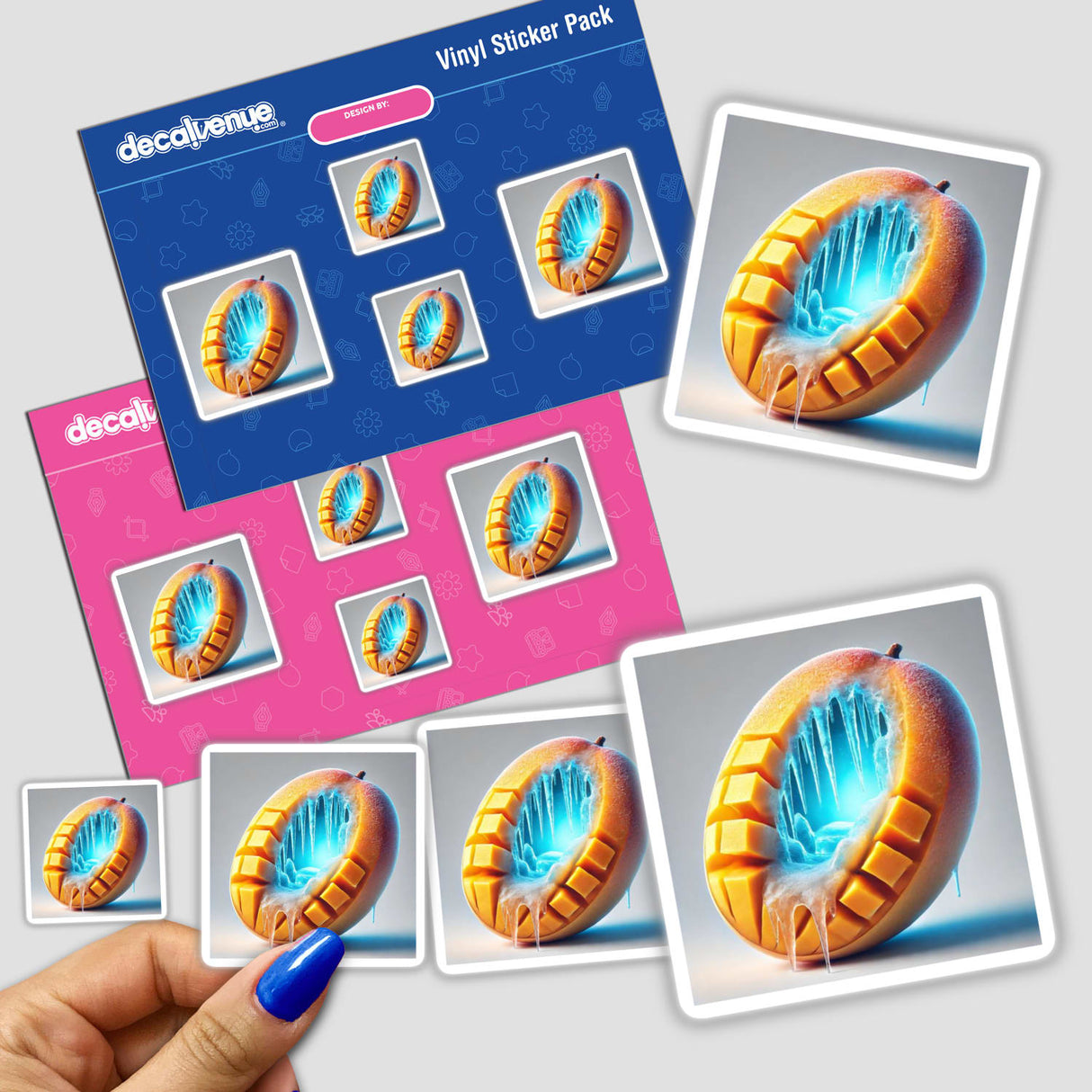 Hand holding a sticker pack titled Frozen Tropics Ice Cave Inside a Mango showing a mango encased in ice and icicles, reflecting Decal Venue's unique sticker and digital art offerings.
