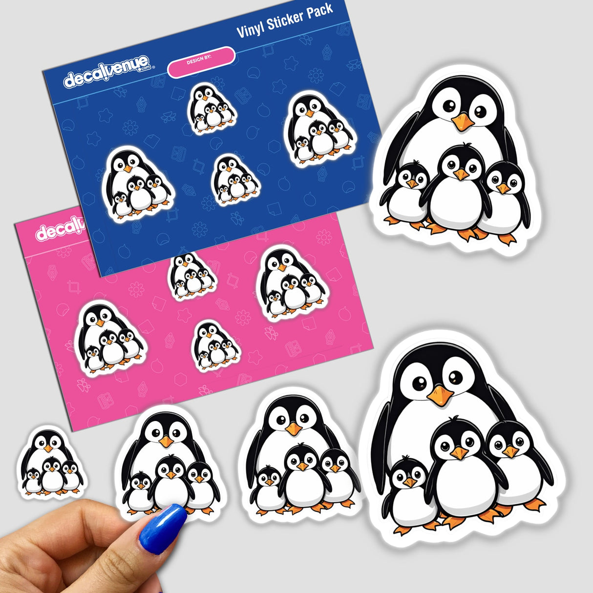Cute family of penguin stickers in various sizes and poses on a vibrant blue and pink background, presented in a vinyl sticker pack from Decal Venue, an online store offering unique stickers and digital art created by talented designers.