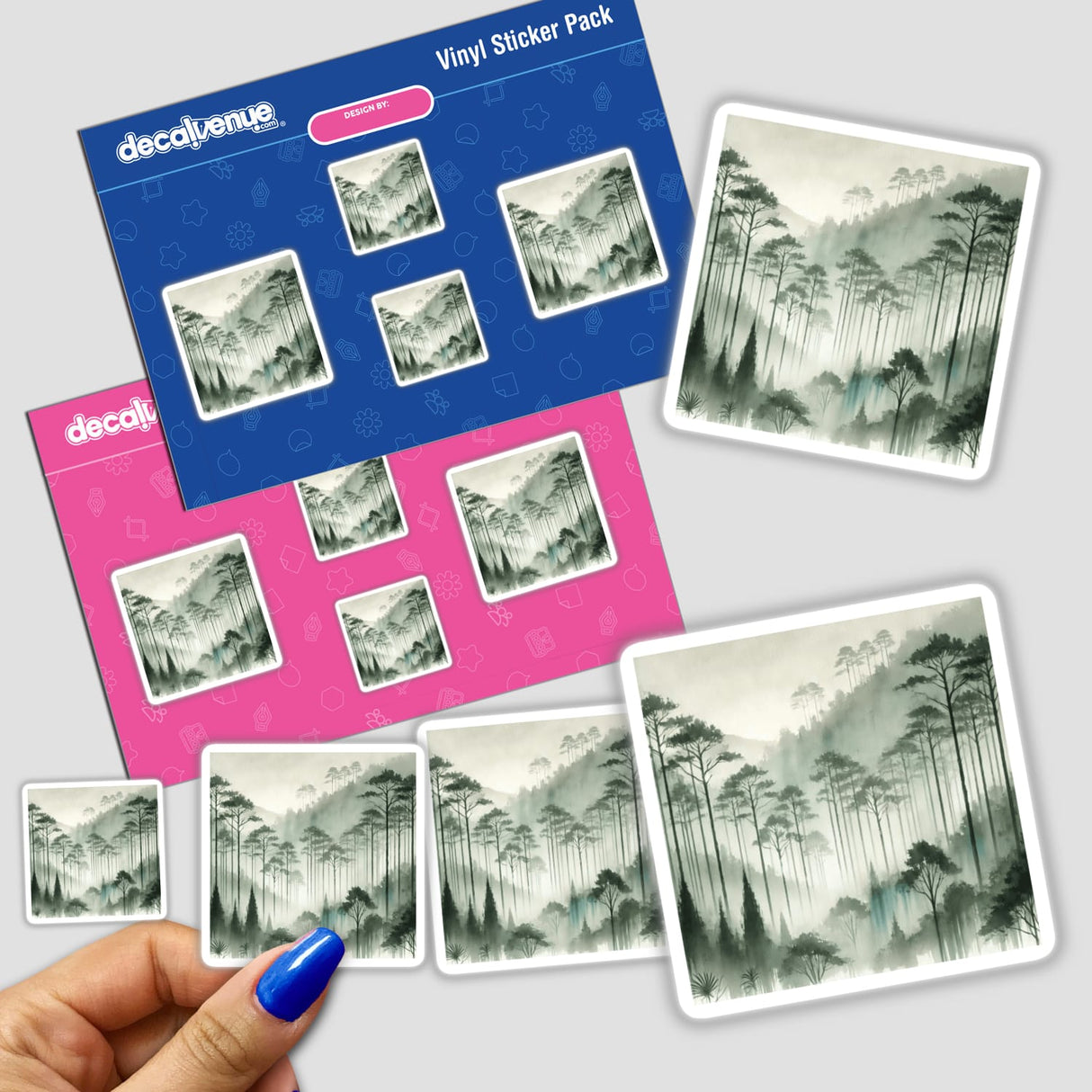 Hand holding Forest Mystique - Watercolor Trees in Misty Fog stickers, featuring trees and mountains in a misty forest design.