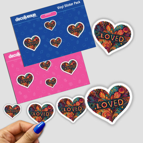 Colorful heart-shaped digital artwork stickers displayed on a Decal Venue product pack. The stickers feature vibrant and intricate patterns in shades of red, orange, and blue, with the word "LOVED" prominently displayed. This product would allow customers to express their style and affection through these unique and eye-catching sticker designs.