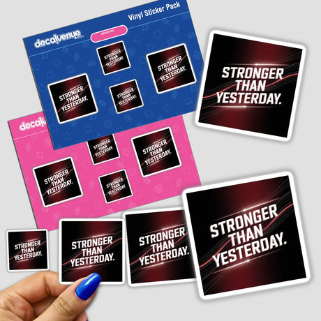 Hand holding a Stronger than yesterday sticker pack, showcasing unique vinyl designs from Decal Venue, specializing in creative stickers and digital art.