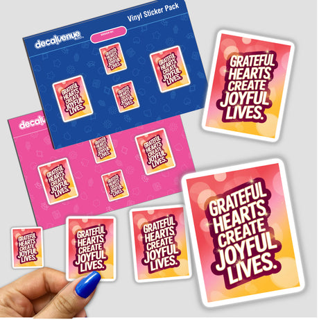 Hand holding a sticker pack titled Grateful hearts create joyful lives, showcasing diverse designs, available as both stickers and digital artwork from Decal Venue.