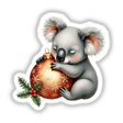Koala Sleeping on Christmas Ornament: A charming illustration of a koala bear peacefully embracing a Christmas ornament, available as unique stickers or digital artwork from Decal Venue.
