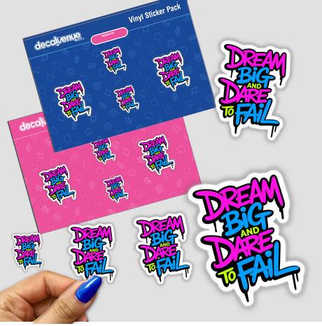 Hand holding a Dream Big And Dare To Fail motivational sticker, showcasing colorful text design, part of Decal Venue's unique vinyl sticker and digital art collection.