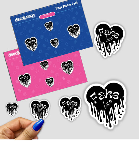 Hand holding a 'Fake Love' sticker pack featuring blue and pink designs with black hearts and white text, showcasing unique graphic design elements from Decal Venue's collection.