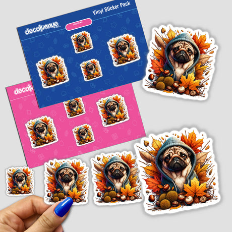 Autumn Pug Dog in Cozy Sweater sticker featuring a cartoon pug in a hoodie surrounded by leaves, shown in a close-up on a surface with a hand displaying blue nail polish nearby.