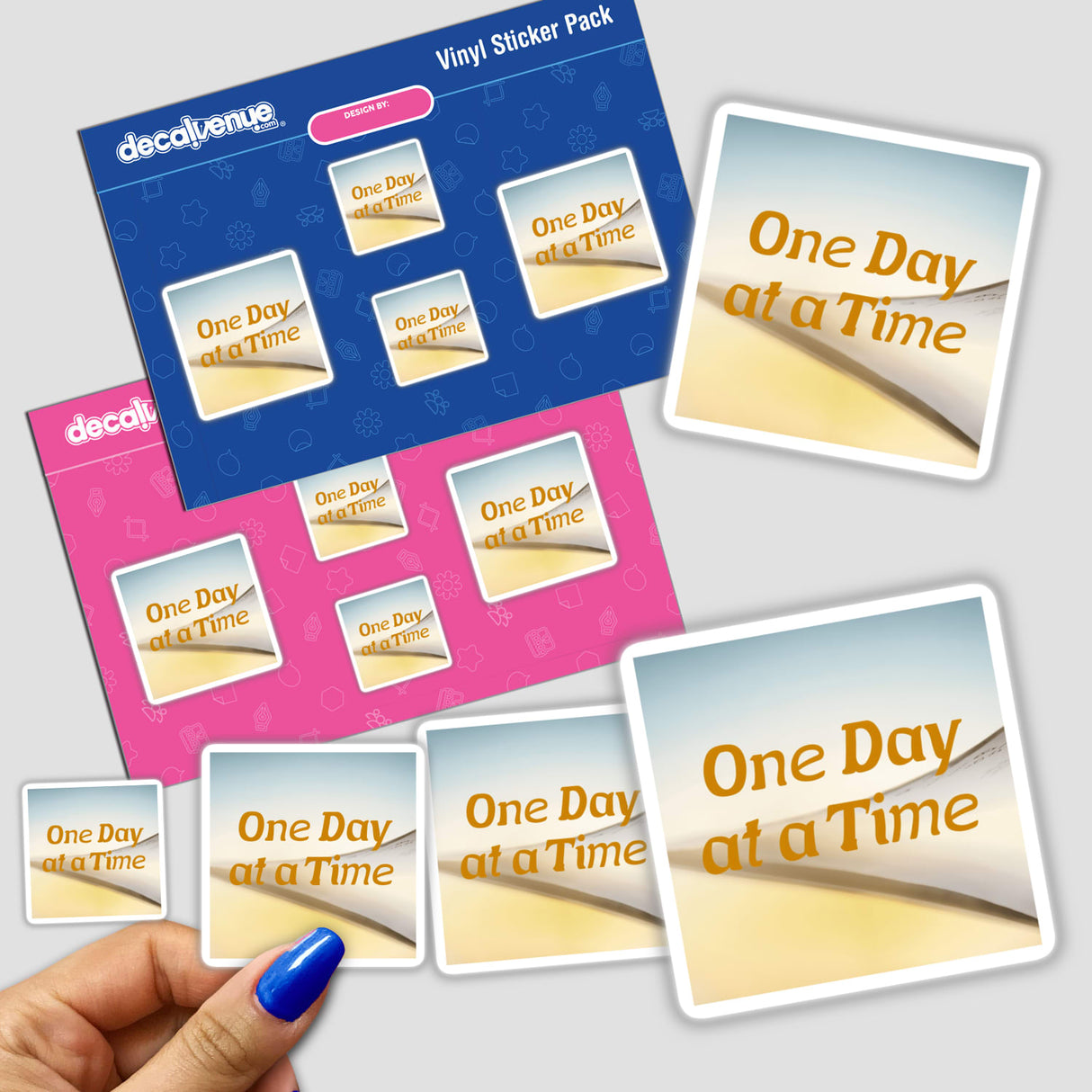 Hand holding One Day at a Time stickers, featuring positive mental health messages, available as physical stickers or digital artwork from Decal Venue.