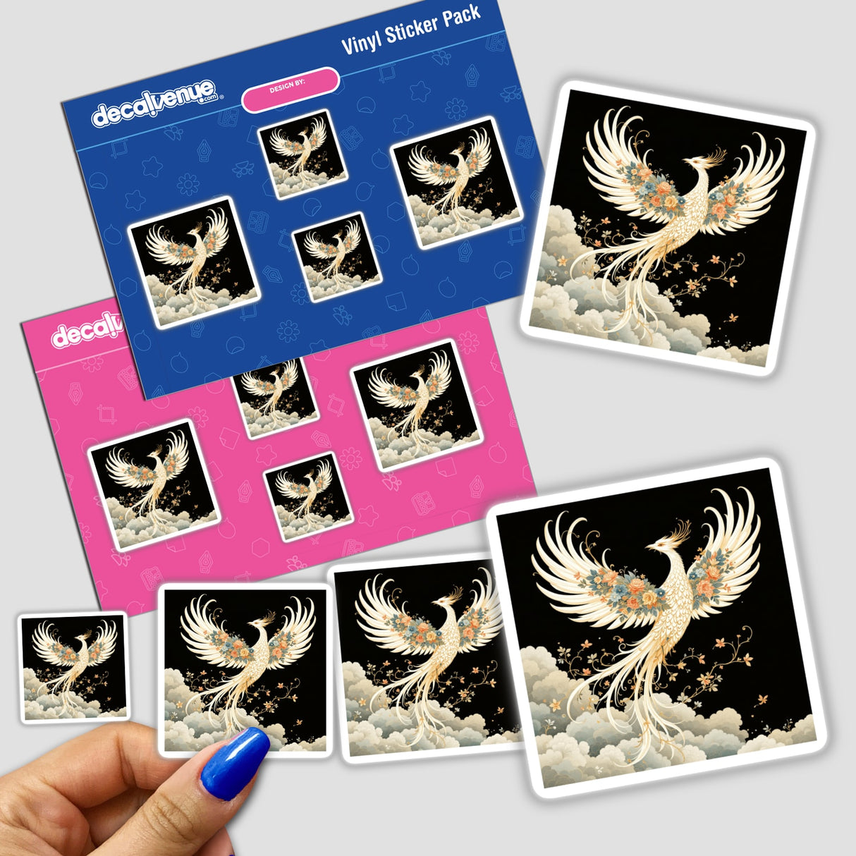 Hand holding Chinoiserie Phoenix stickers, featuring a detailed white phoenix adorned with flowers, available as both stickers and digital artwork from Decal Venue.