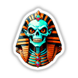 A Cool Egyptian Pharaoh Skull cartoon features a skeleton adorned with a gold and orange crown, Egyptian garment, and colorful gems, available as stickers or digital artwork.