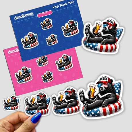 Hand holding a Black Bear American Flag Float Merica sticker featuring a bear in sunglasses and a hat, sitting on a bean bag with a beer.