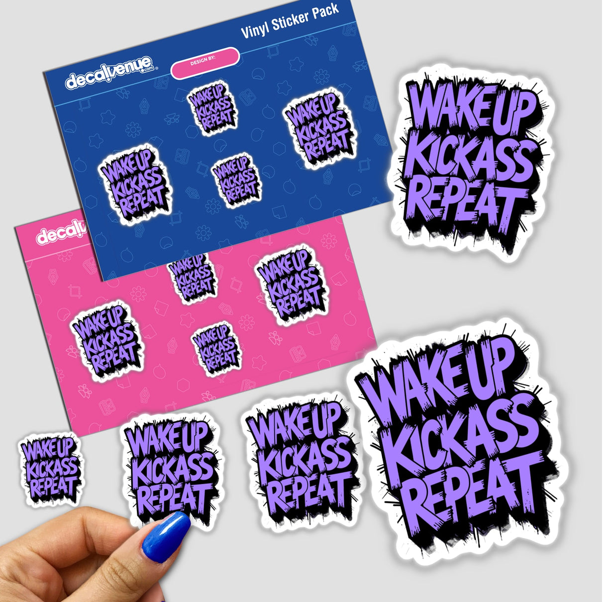 Wake Up Kick Ass Repeat Funny Quote sticker, featuring bold text design, showcased on a surface with additional stickers, highlighting its unique and motivational theme from Decal Venue.