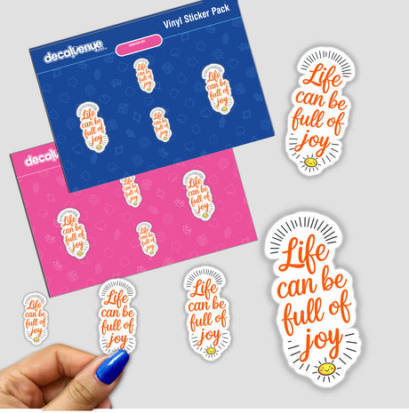 A hand holds Life Can Be Full Of Joy motivational stickers, featuring bold, clear text, available as physical stickers or digital artwork from Decal Venue.