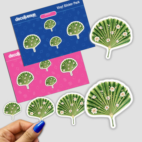 Hand holding a sticker of Chinoiserie Fan Leaf Palm, featuring intricate green fan design with white flowers, available as a sticker or digital artwork from Decal Venue.