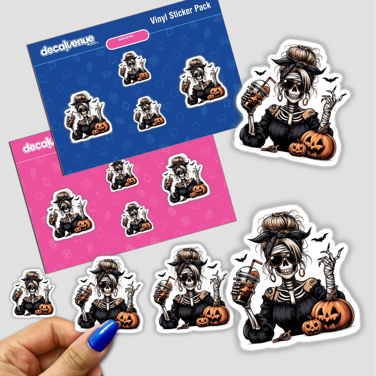 Spooky Halloween mummy skeleton lady vinyl stickers with pumpkins, bats, and other eerie elements on a pink and blue background.